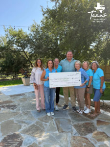 Group photo of Sisters in Service with Ryan Pendergraft and their Donation Check
